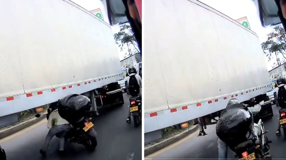 Motociclista intenta pasar debajo de una tractomula para evitar trancón